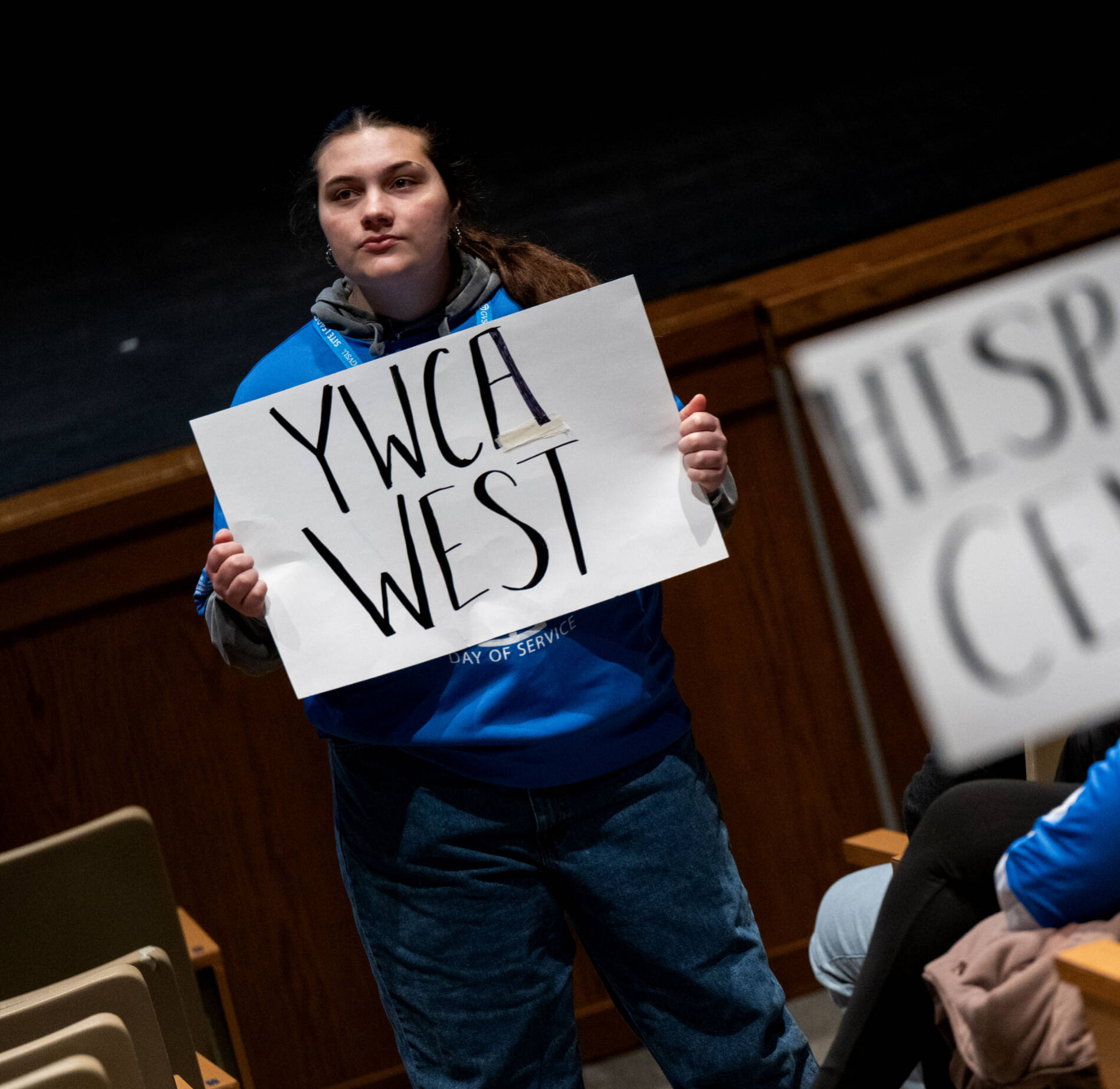 student holding site signs